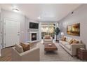 Elegant living room with a fireplace, plush seating, and a sliding glass door leading to a balcony with great views at 3890 S Dayton St # 105, Aurora, CO 80014