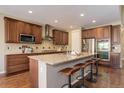 Spacious kitchen with granite countertops, stainless steel appliances, and a large island at 15265 W Baker Ave, Lakewood, CO 80228