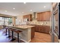 Spacious kitchen with granite countertops, stainless steel appliances, and a large island at 15265 W Baker Ave, Lakewood, CO 80228