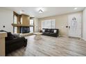Cozy living room featuring a fireplace, hardwood floors, and comfortable leather seating at 5293 Malaya St, Denver, CO 80249