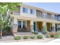 Lovely exterior featuring a covered porch with brick accents and manicured landscaping at 8321 E 33Rd Ave, Denver, CO 80238