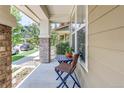 Inviting front porch with bistro set, perfect for enjoying quiet mornings at 8321 E 33Rd Ave, Denver, CO 80238