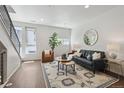 Bright living room showcasing modern decor, hardwood floors, and an elegant round mirror at 1711 Hooker St # 2, Denver, CO 80204