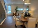 Open-concept living room with modern decor, wood floors, staircase and big windows create an airy and bright atmosphere at 1711 Hooker St # 2, Denver, CO 80204