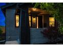 Charming front porch with brick accents and well-lit windows, creating a warm and inviting entrance at 3105 N Elizabeth St, Denver, CO 80205