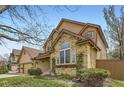 Charming home with a blend of brick and siding, complemented by lush landscaping at 1604 Brookside Dr, Highlands Ranch, CO 80126
