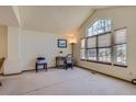 Bright living room featuring vaulted ceilings and large windows offering ample natural light at 1604 Brookside Dr, Highlands Ranch, CO 80126