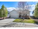 Charming single Gathering home with a two car garage, landscaped yard, and covered front porch at 401 Clubhouse Dr, Fort Lupton, CO 80621