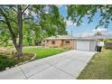 A charming brick home with a well-manicured lawn and long concrete driveway at 9150 Fir Dr, Thornton, CO 80229