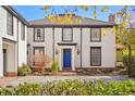 Charming two-story home with a blue front door and manicured landscaping at 2 Fieldstone Trl, Englewood, CO 80113