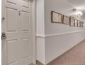 Hallway with carpet, white walls, and framed artwork at 13931 E Marina Dr # 402, Aurora, CO 80014