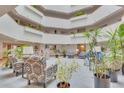 Spacious atrium lobby with seating areas and natural light at 13931 E Marina Dr # 402, Aurora, CO 80014