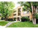 Attractive brick apartment building with well-maintained lawn and landscaping at 85 N Ogden St # 34, Denver, CO 80218