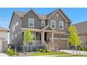 Charming two-story home featuring a covered front porch, well-maintained lawn and two-car garage at 864 Clover Loop, Erie, CO 80026