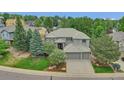 Expansive home with mature trees, a manicured lawn, and a three-car garage is nestled in a lovely residential neighborhood at 877 Eldorado Dr, Superior, CO 80027