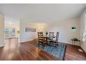 Cozy dining room featuring wood floors, a round table with seating for four, and a stylish area rug at 2166 S Joplin Way, Aurora, CO 80013