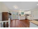 Bright, spacious kitchen with white cabinets, modern appliances, wood floors, and easy access to the backyard at 2166 S Joplin Way, Aurora, CO 80013