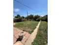 Spacious backyard with a narrow concrete walkway and a shed at 460 Yates St, Denver, CO 80204