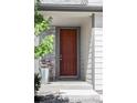 Close-up of a classic red front door with stone and siding accents on a well maintained house at 6117 Easton Cir, Frederick, CO 80504
