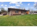 Home exterior showcasing a well-kept lawn and convenient carport with street access on a sunny day at 3746 S Fairplay Way, Aurora, CO 80014
