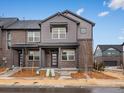 Inviting two-story townhome with brick accents, a covered porch, and manicured landscaping at 754 N Tempe St, Aurora, CO 80018