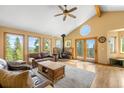 Bright living room with hardwood floors, a wood-burning stove, and scenic views at 10090 Blue Sky Trl, Conifer, CO 80433