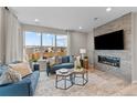 Cozy living room with large windows, stylish decor, and a modern fireplace at 9487 W 58Th Ln # C, Arvada, CO 80002