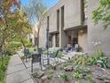 Landscaped backyard with seating and stepping stone pavers surrounded by foliage and mature trees at 1070 Race St # H, Denver, CO 80206
