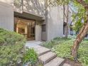 Townhouse featuring lush landscaping around the home, steps leading to front entrance, and large windows at 1070 Race St # H, Denver, CO 80206