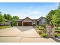 Charming single-story home with an extra long driveway, three-car garage and perfectly landscaped front yard at 4532 Christensen Cir, Littleton, CO 80123