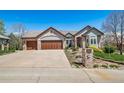 Beautiful brick home featuring a three-car garage and well-maintained landscaping, including house number at 4532 Christensen Cir, Littleton, CO 80123