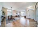 Bright and spacious living room and dining area with hardwood floors and large windows with plenty of light at 4532 Christensen Cir, Littleton, CO 80123