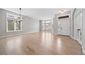 Spacious living room boasts gleaming hardwood floors and large windows filling the space with natural light at 4532 Christensen Cir, Littleton, CO 80123