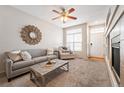 Bright living room boasts a modern sofa, decorative mirror, and lots of natural light at 9763 E Carolina Pl, Aurora, CO 80247