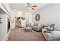 Inviting living room featuring plush carpeting, a cozy fireplace, and a comfortable seating area at 9763 E Carolina Pl, Aurora, CO 80247