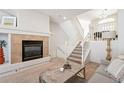 Comfortable living room with a fireplace and a staircase, perfect for relaxation and convenience at 9763 E Carolina Pl, Aurora, CO 80247