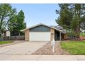 Charming single-story home with a brick exterior, a two-car garage, and a well-manicured front yard at 2495 S Lansing Way, Aurora, CO 80014