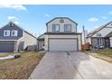 Two-story house with gray siding, attached garage, and small front yard at 5428 W 115Th Dr, Westminster, CO 80020