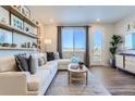 Cozy living room with a comfortable sectional sofa, decorative shelves, and a large window at 14151 Deertrack Ln, Parker, CO 80134