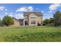 Spacious backyard featuring a well-maintained lawn and a charming two-story home at 5605 Killen Ave, Castle Rock, CO 80104