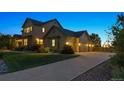 Charming two-story home with a spacious three car garage and well-maintained landscaping at dusk at 5605 Killen Ave, Castle Rock, CO 80104