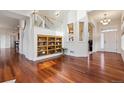 Bright foyer with hardwood floors, open staircase and display shelving at 5605 Killen Ave, Castle Rock, CO 80104