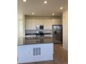 Modern kitchen featuring an island, stainless steel appliances, and white cabinetry at 6739 Juniper Dr, Thornton, CO 80602
