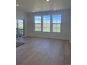 Bright and airy living room featuring three windows offering scenic outdoor views at 6739 Juniper Dr, Thornton, CO 80602