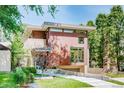 Contemporary two-story home with a modern design, clean lines, and lush greenery at 421 Dexter St, Denver, CO 80220