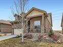 Charming home featuring a two-car garage, stone accents, dormer windows, and covered porch at 4420 White Rock Dr, Broomfield, CO 80023