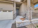 Inviting front porch with stone pillars and a well-manicured front yard enhance this home's curb appeal at 4420 White Rock Dr, Broomfield, CO 80023