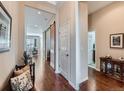 Inviting hallway featuring hardwood floors, sliding barn door, and access to various rooms at 4420 White Rock Dr, Broomfield, CO 80023