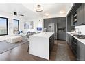 Open floor plan with a modern kitchen, large island, and comfortable living space at 1750 Wewatta St # 1521, Denver, CO 80202