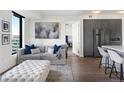 Bright living room features a comfortable sofa and city views at 1750 Wewatta St # 1521, Denver, CO 80202